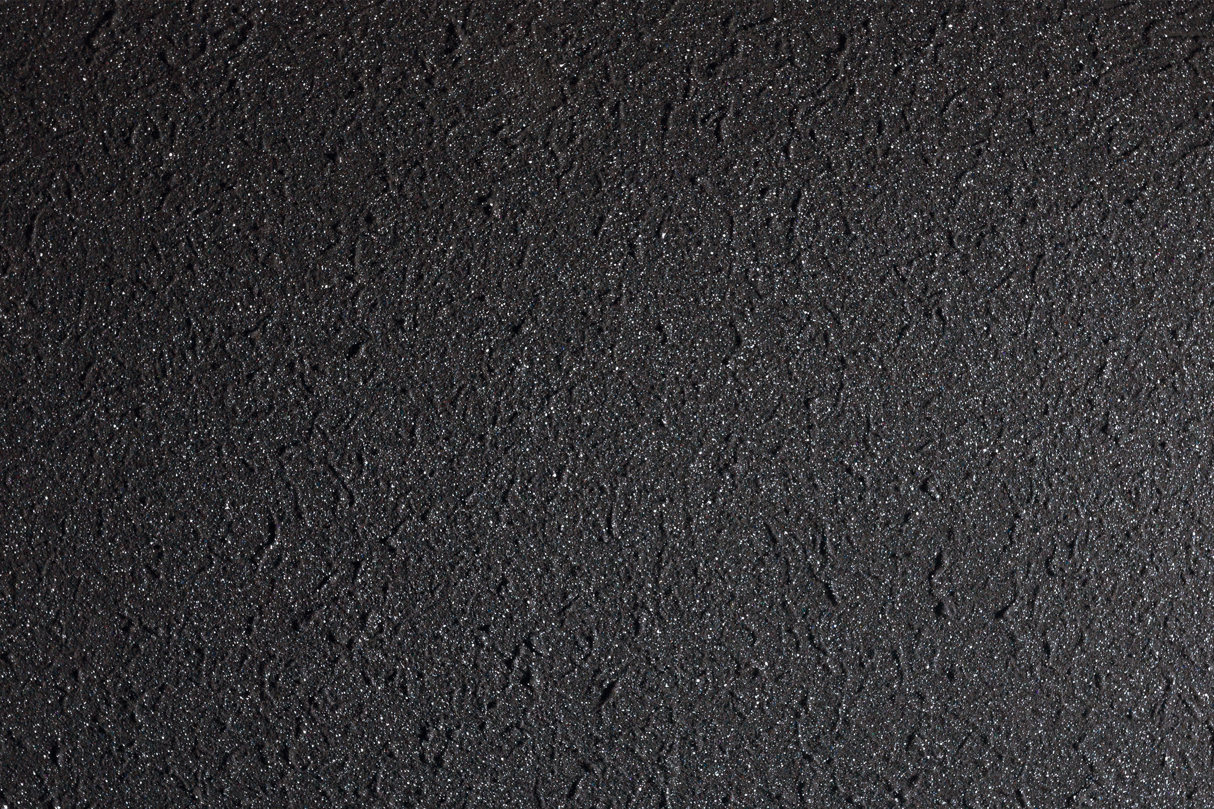 Mörkgrå lavastensliknande yta.